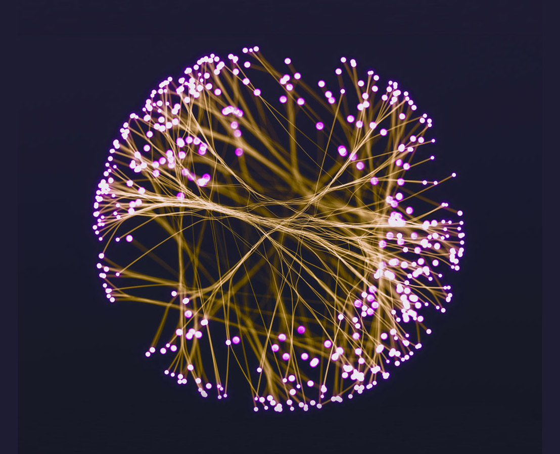 Krogla med seboj povezanih rumenih niti, ki na koncu žarijo v vijolični barvi.